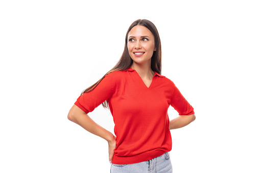 pretty caucasian woman with black hair is wearing a red blouse with a v-neck on a white background with copy space.