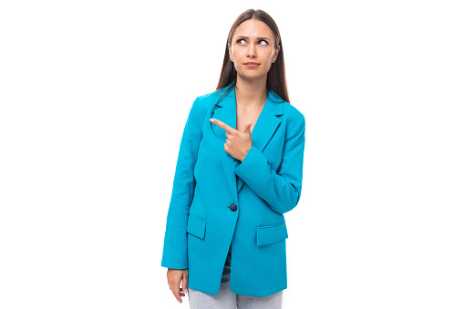 young pretty brunette secretary woman in blue jacket talking about news gesturing on isolated white background with copy space.