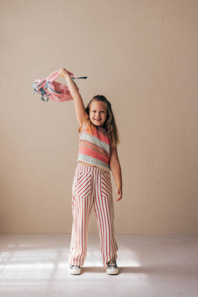 istock Back to School: Cute Caucasian Schoolgirl Waving her Backpack Playfully 1636617300