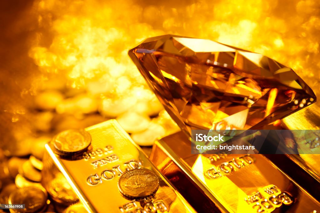 Amber diamond on gold bars http://www.gunaymutlu.com/iStock/financial-images-360.jpg Diamond - Gemstone Stock Photo