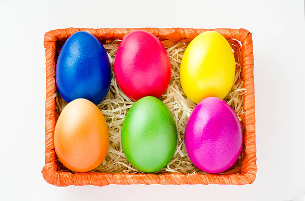 Six colored easter eggs in basket stock photo