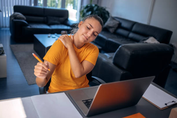 istock Young woman feeling pain while working home office using laptop 1636632042