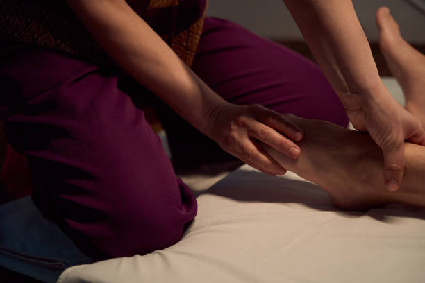 istock Experienced massotherapist is doing Thai feet massage to spa customer 1636672512
