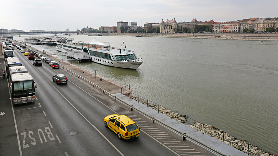 Budapest, Hungary - July 13, 2015: Long Cruise Ships Moored at Danube River Coast in Capital City Summer Day.