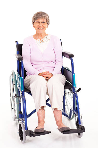 istock happy elderly woman sitting on wheelchair 163668683