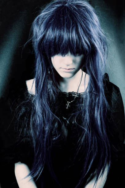 Dark woman portrait Portrait of a young woman with messy long hair, wearing a beautiful gothic dress, looking down. black hair emo girl stock pictures, royalty-free photos & images