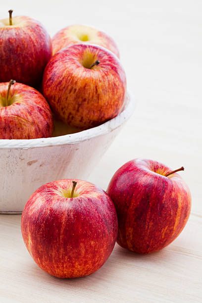 Royal gala apples on wooden background