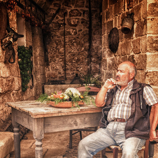 istock Senior farmer man smoking cigar 163669471