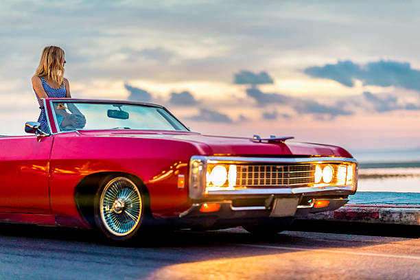 istock Woman watching sunset in retro car 163673859