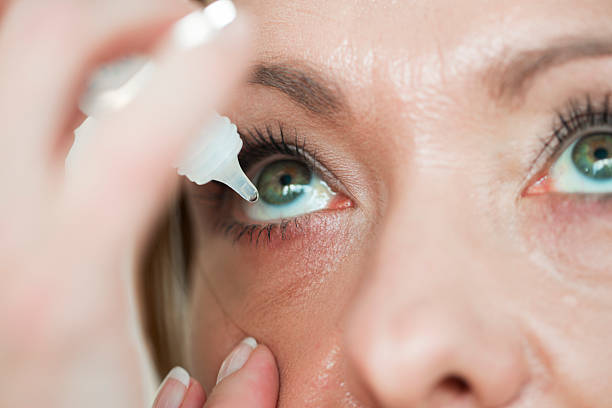 Woman usind eyedropper...applying eye drops Woman usind eyedropper...applying eye drops dry eye stock pictures, royalty-free photos & images