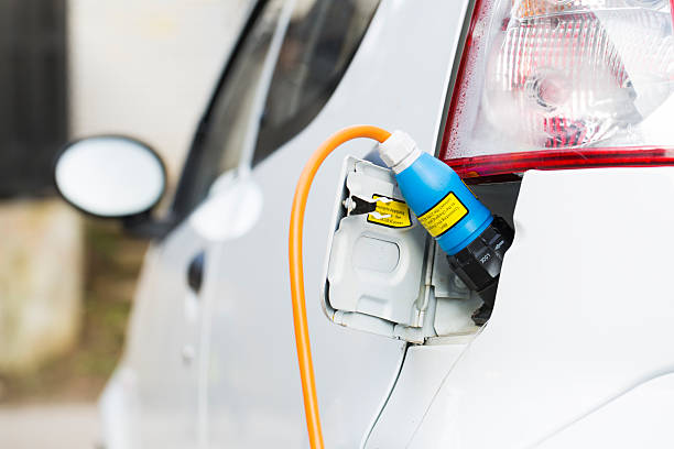 istock Closeup of an electric car plug while recharging 163674157