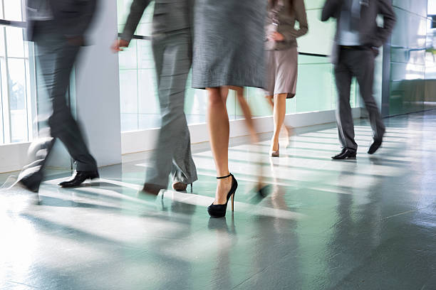 istock Group of business people walking on corridor 163674419