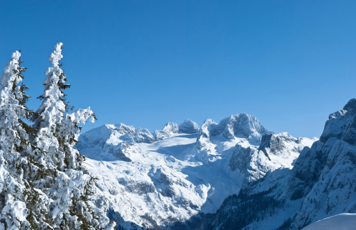 Great wide angle shot of the upper austrian alps and its most famous peak, Hoher Dachstein. The area of Salzkammergut is a world heritage site with millions of skiing and hiking tourists every year. Enjoy this fantastic view from Zwieselalm on this perfect sunny day. Mountain peak: 9,826 ft / 2,995 m.