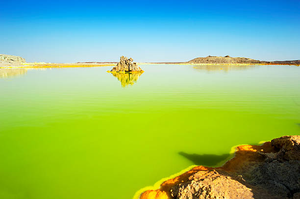 Inside the explosion crater of Dallol volcano, Danakil Depression, Ethiopia The volcanic explosion crater of Dallol in the Danakil Depresseion in Nothern Ethiopia. The Dallol crater was formed during a phreatic eruption in 1926. This crater is known as the lowest subaerial vulcanic vents in the world. The surreal colours are caused by green acid ponds and iron oxides and sulfur. dallol ethiopia stock pictures, royalty-free photos & images