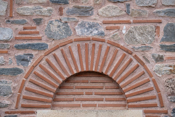 istock Arch of brick on ancient stone wall. 1636761138