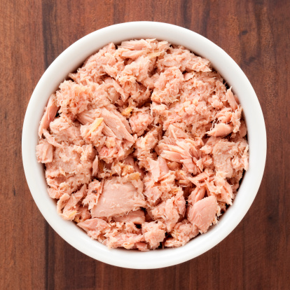Top view of white bowl full of canned tuna