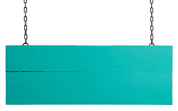 Old weathered turquoise wood signboard.