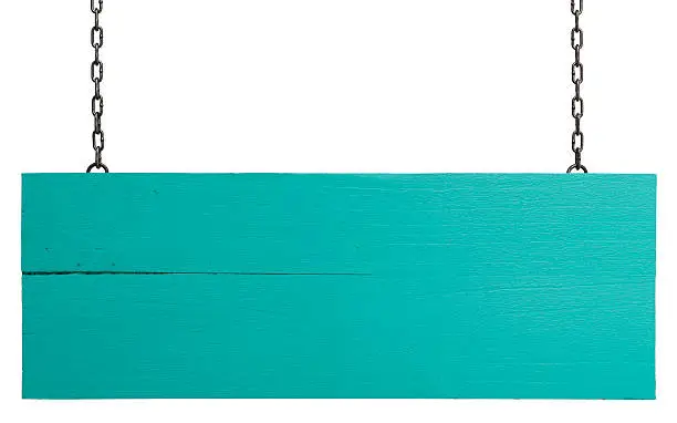 Photo of Old weathered turquoise wood signboard.