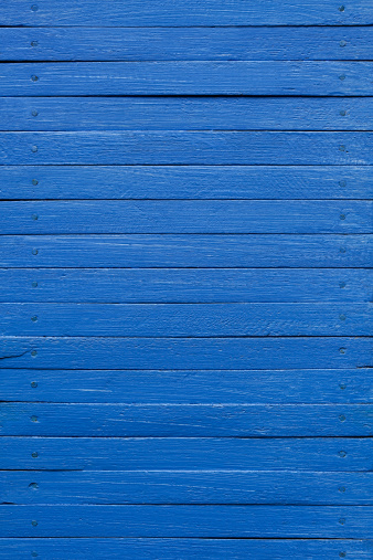 Old blue painted wooden board background.