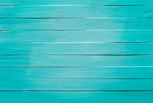 Old turquoise wooden panel background.