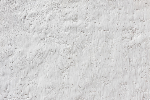 Grunge old white stucco wall background.