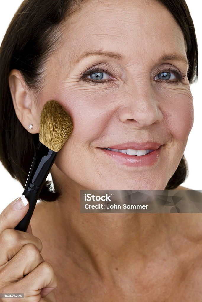 Woman applying makeup Headshot of a mature woman applying makeup Foundation Make-Up Stock Photo