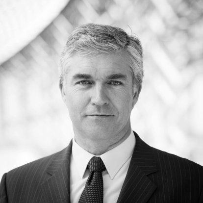 Black and white head and shoulders business portrait of a mature business manager or Chief Executive.