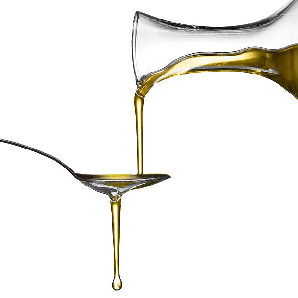 istock Pouring oil on spoon isolated 163677490