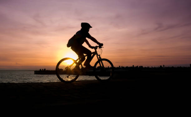 istock Silhouette of cyclist biking at the sunset 1636779470