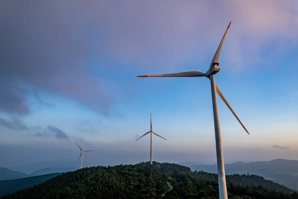istock Wind power is installed on foggy mountains covered by forests 1636793345