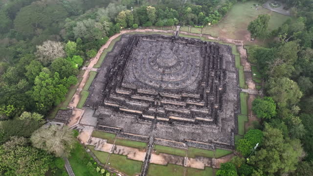 Aerial drone sunrise scene of the ancient ruins of Borobudur, a 9th-century Mahayana Buddhist temple in Magelang Regency near Yogyakarta in Central Java, Indonesia.