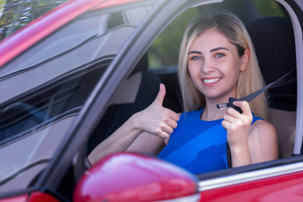 istock woman driver wearing seat belt 1636830592