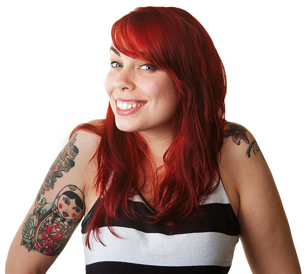 Cute proud young woman in red hair with tattoos