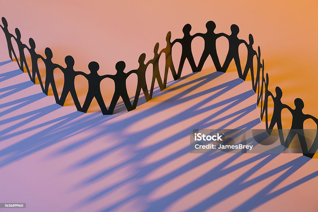 Paper Men Joining Together As Team, Union, Family or Network  Charity and Relief Work Stock Photo