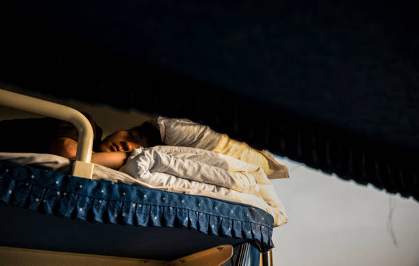 istock Chinese boy lying on bed in train. China 1636913633