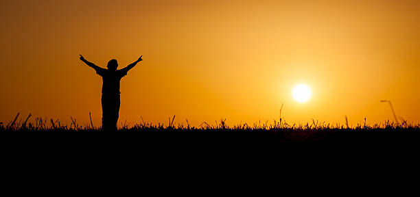 istock Person celebrating life at sunset 163691840