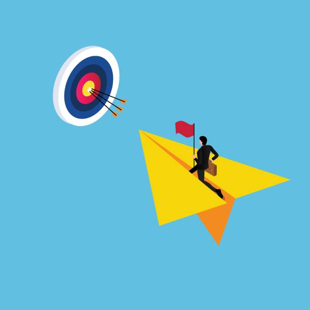 istock Businessman holding a flag on paper plane flying to dart board 1636922698