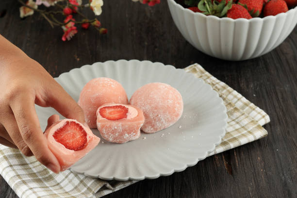 istock Female Hand Take Strawberry Daifuku Mochi 1636925784
