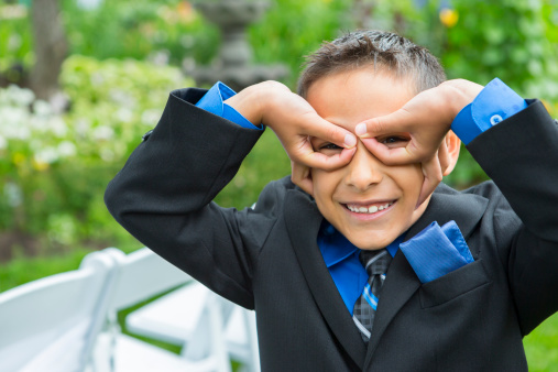 Boy being playful at wedding outdoor
