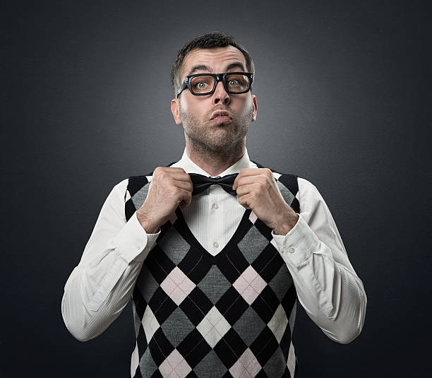 Funny fshion nerd Funny nerd preparing to go out for a date isolated over dark gray background blind date stock pictures, royalty-free photos & images