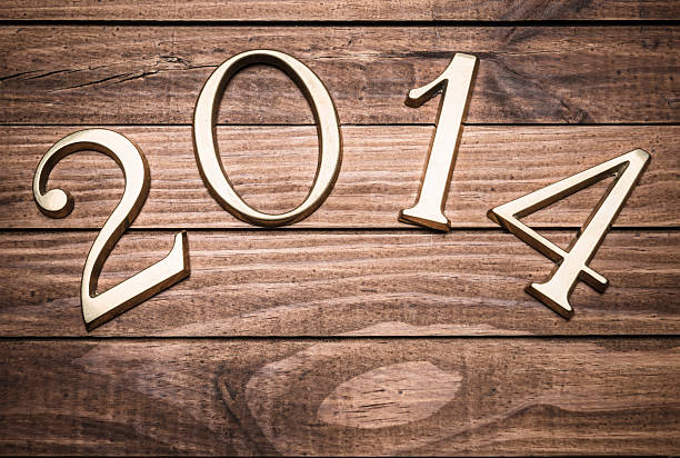 istock 2014 gold numbers on wood background 163702522