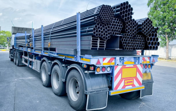 istock Trucks with long trailers carrying steel bars for building construction. Construction steel is ready to be delivered to the customer. 1637028117