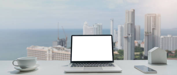 istock Image of working space by the window equipment in office interior, open laptop computer with mock up screen 1637142230
