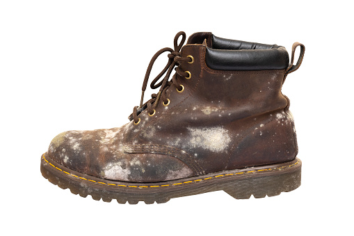 Side view of old brown leather shoes on white background.