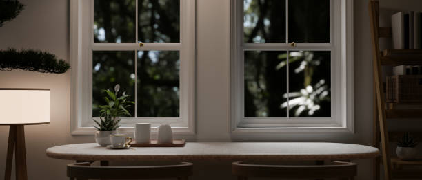 istock Copy space on a dining table by the window in a cozy, minimalist room in the evening 1637189554