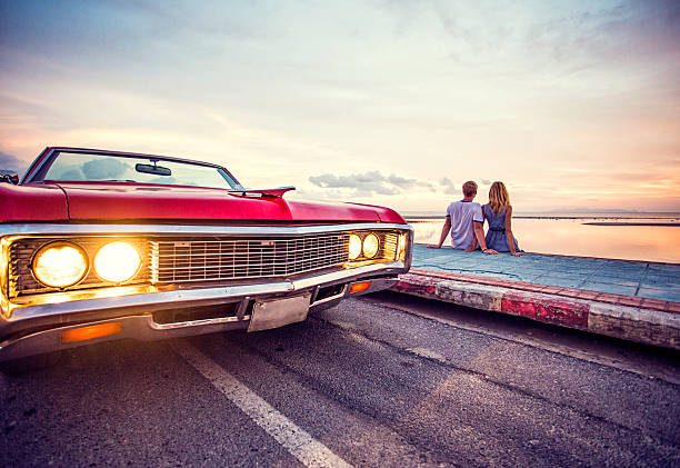 istock Romantic couple watching sunset with retro car 163720625