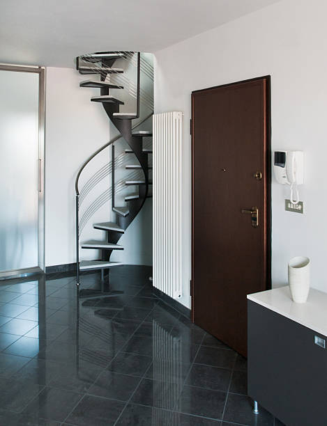 istock Interior entrance with tiled floor and modern spiral staircase 163722171