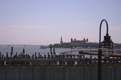 Statue of Liberty and Brooklyn bridge captured from New Jersey shore on the Hudson river