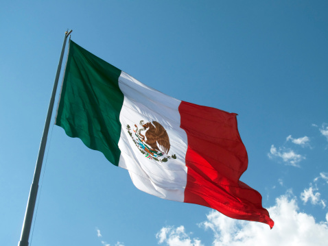Mexican national flag waving in the wind. Mexico is a country in the southern portion of North America. Fabric textured background. Selective focus. Realistic 3d illustration