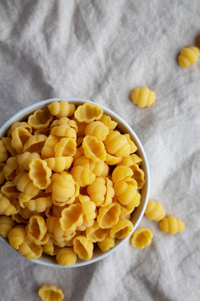 istock Dry Organic Gnocchi Pasta in a Bowl, top view. Flat lay, overhead, from above. Copy space. 1637251879